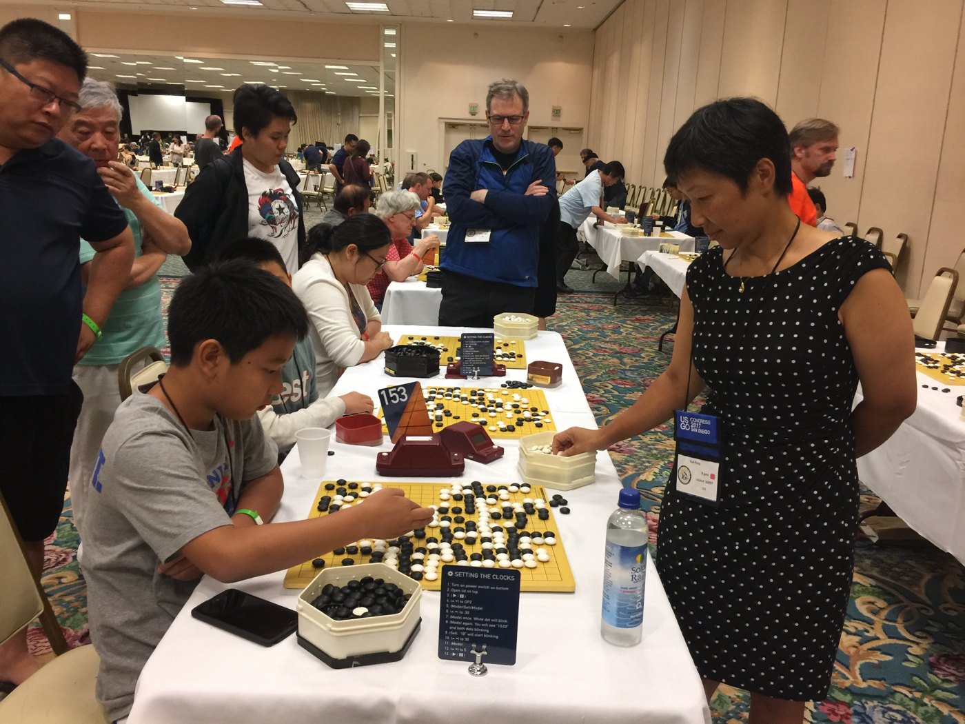 A 9-dan professional reviewing stones at Alan’s board during the 2017 US Go Congress