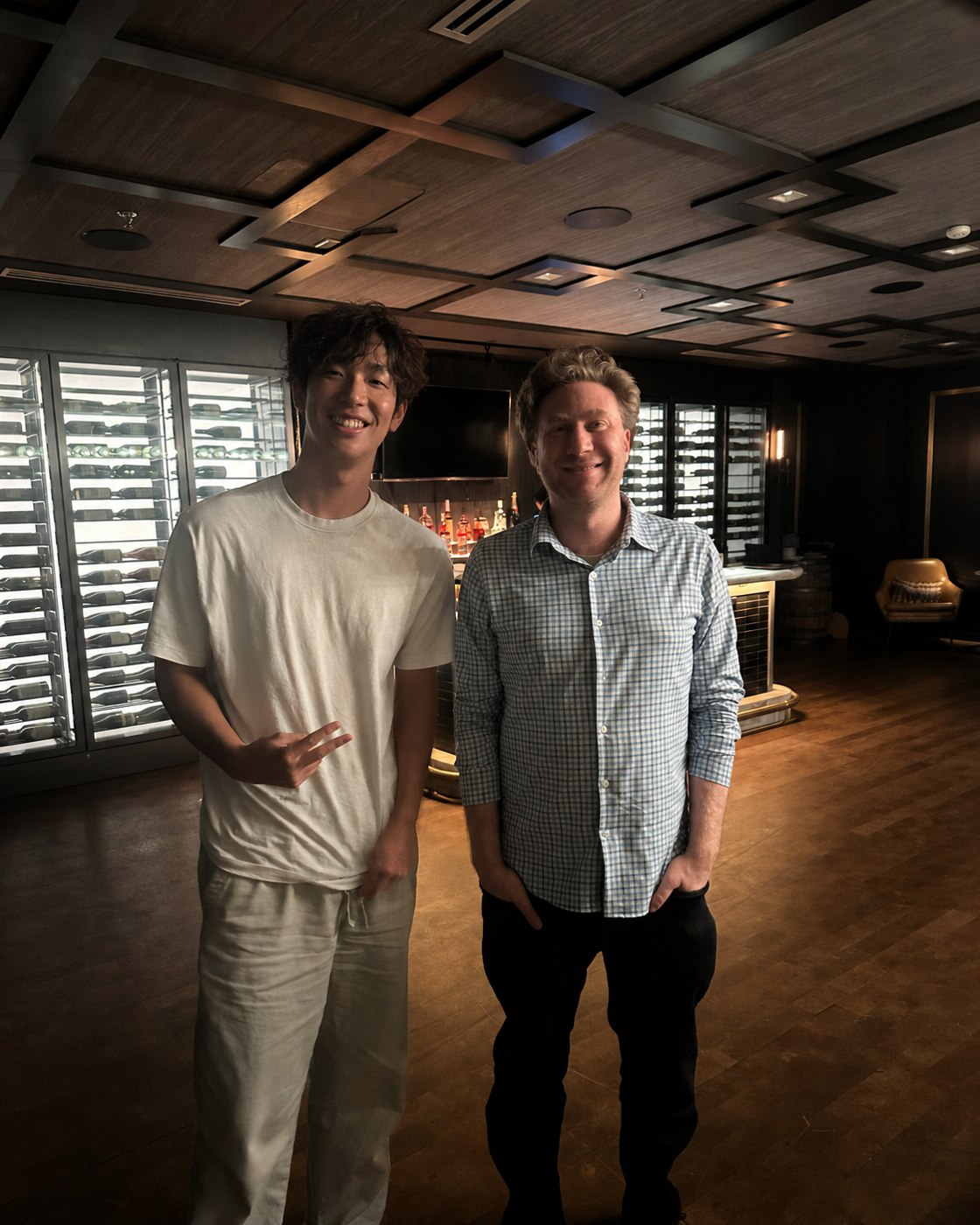 Alan standing with Jared Friedman at a Y Combinator dinner in 2025